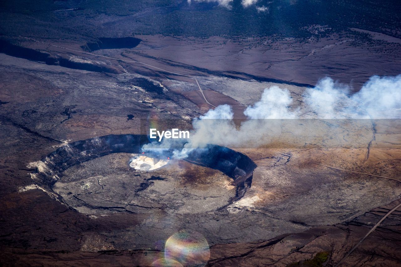 HIGH ANGLE VIEW OF SMOKE EMITTING FROM ROCKS