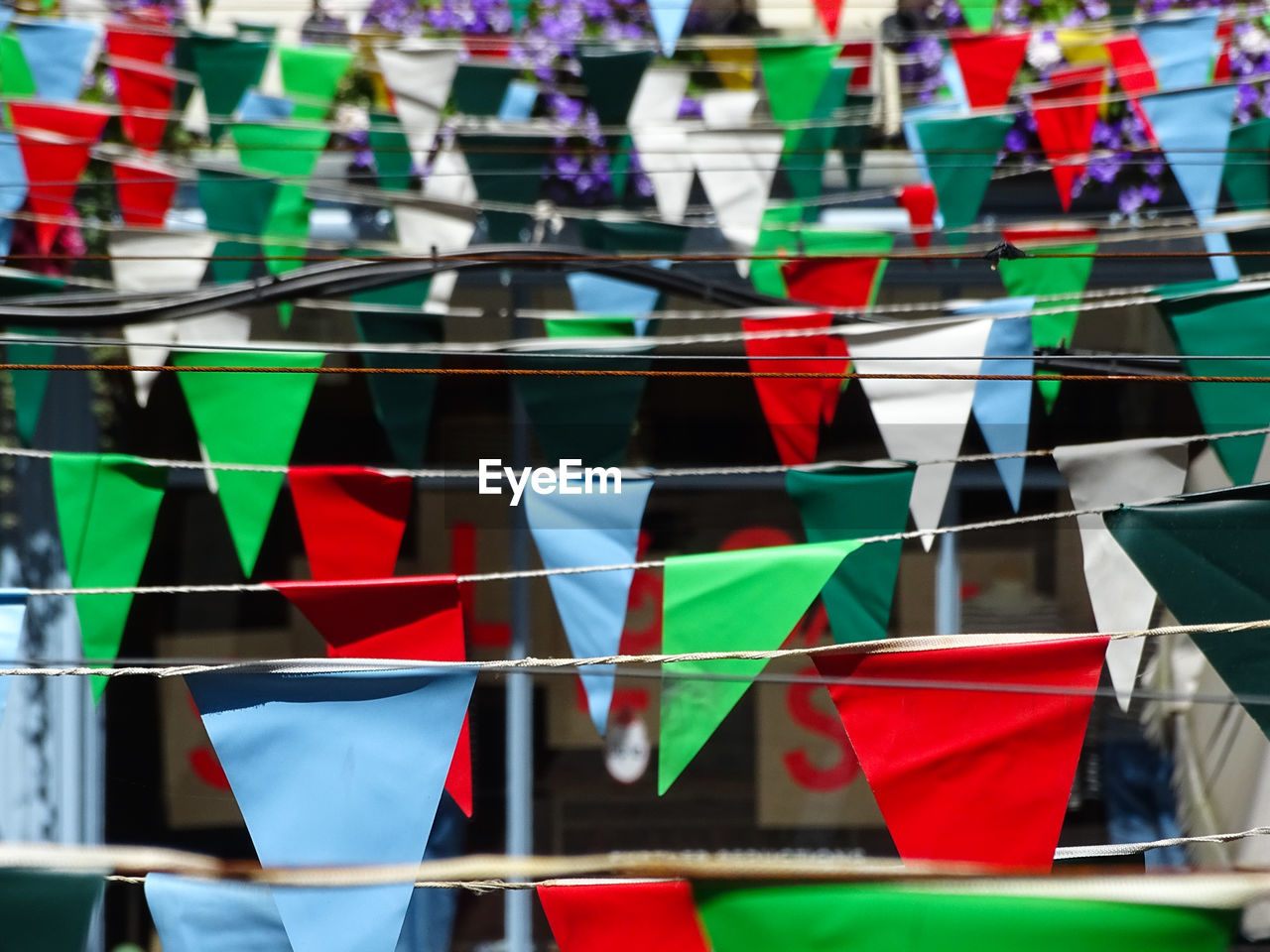 CLOSE-UP OF COLORFUL FLAGS AGAINST BLURRED BACKGROUND