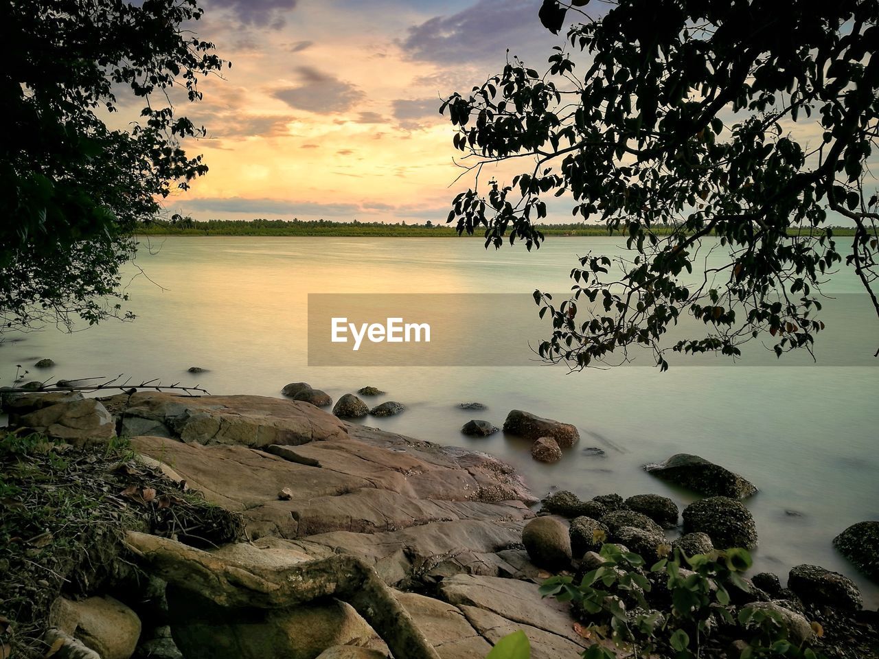 Scenic view of lake against sky during sunset