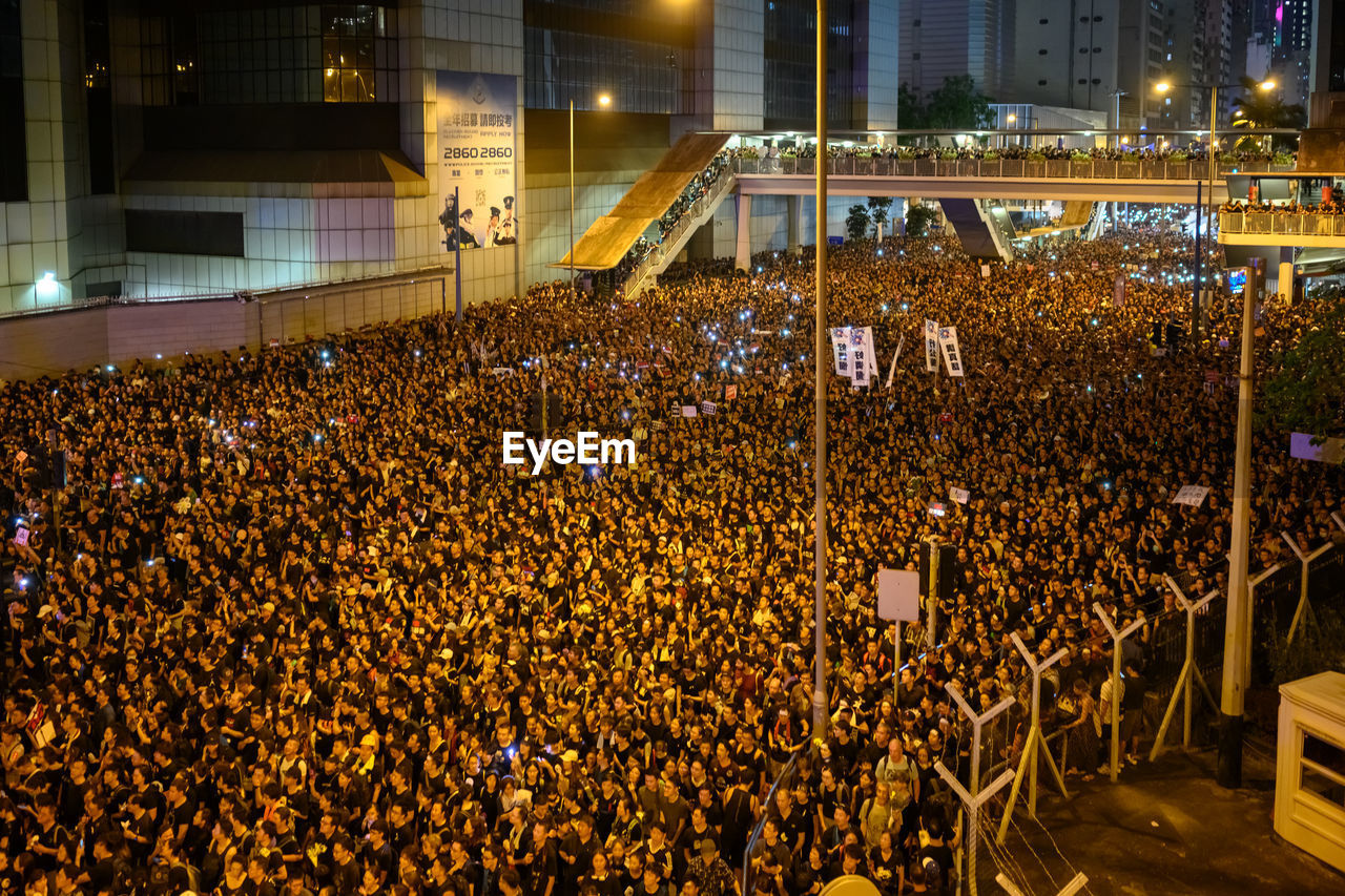 Crowd on road during protest in city at night