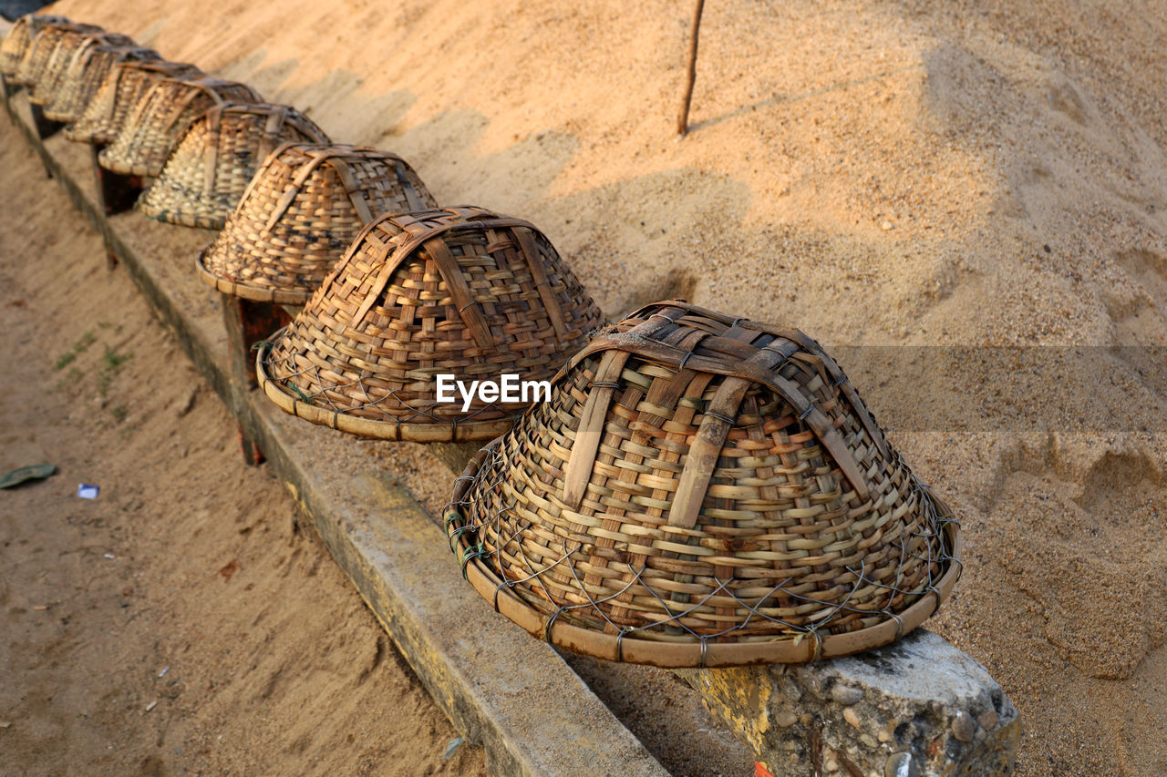 basket, reptile, high angle view, wicker, no people, wood, day, nature, land, container, sand, outdoors, beach, ancient history, animal