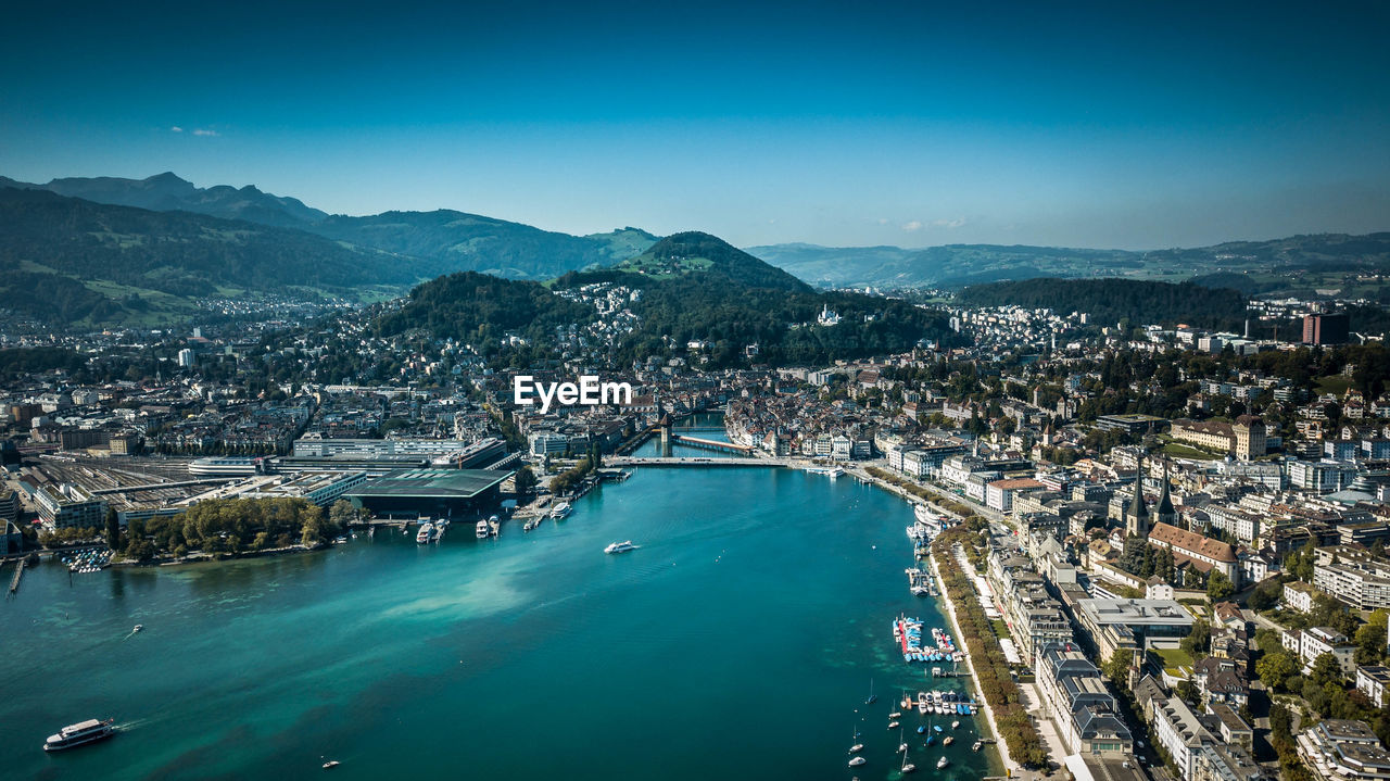 High angle view of city by sea against sky