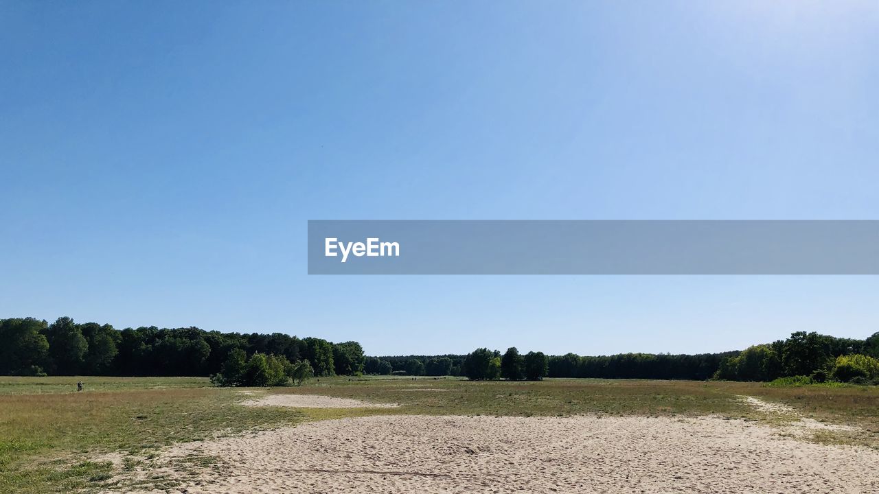 Scenic view of land against clear blue sky