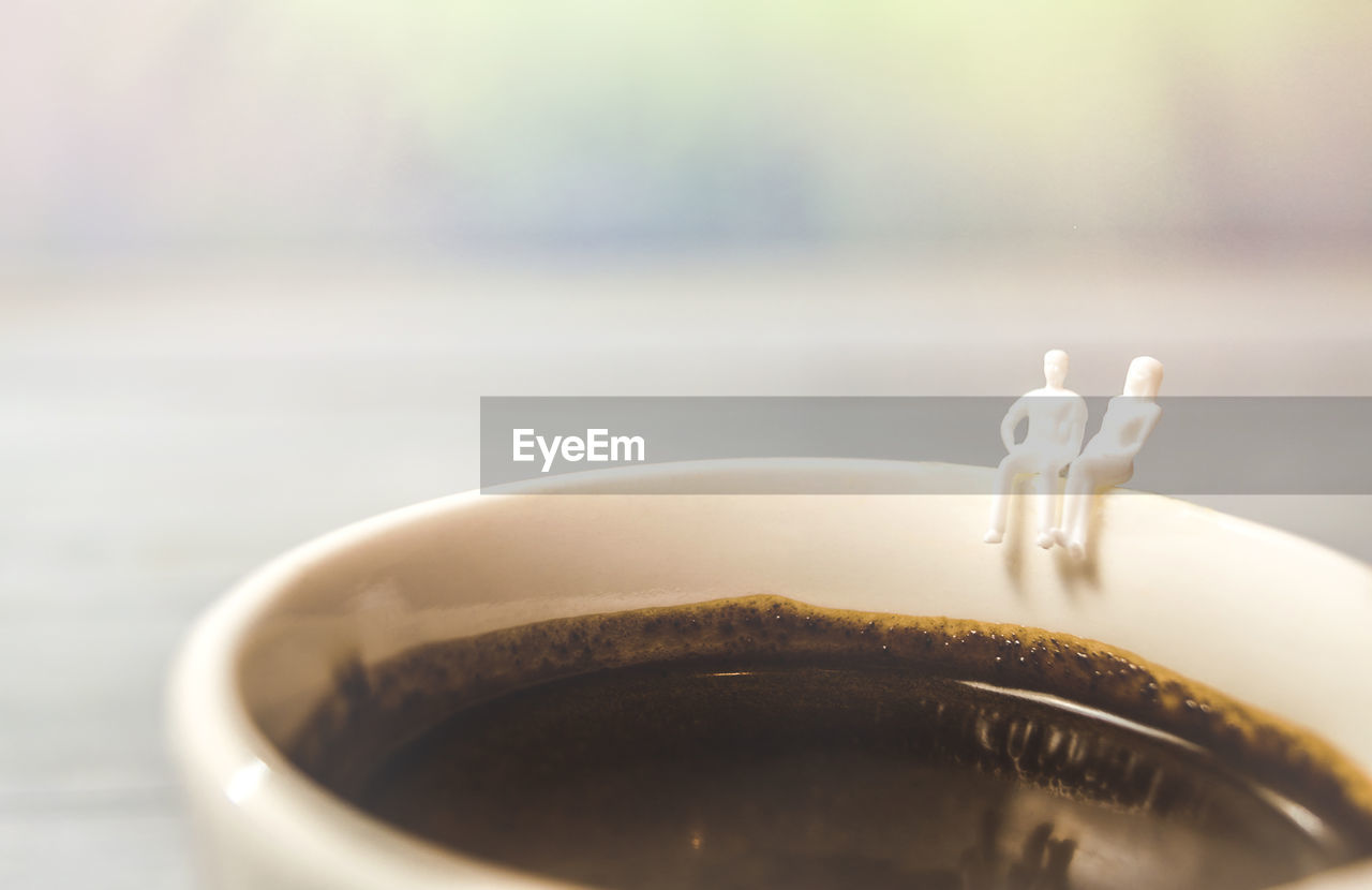 CLOSE-UP OF COFFEE CUP ON WHITE TABLE