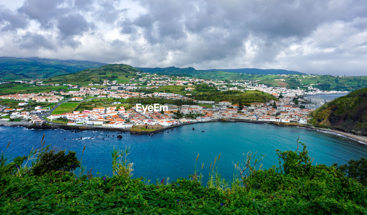 water, sea, architecture, sky, nature, land, cloud, coast, environment, landscape, building exterior, travel destinations, city, building, scenics - nature, travel, built structure, beach, mountain, body of water, nautical vessel, bay, beauty in nature, no people, plant, tourism, coastline, house, harbor, residential district, outdoors, cityscape, town, tree, high angle view, shore, trip, vacation, transportation, day, holiday, aerial photography, village, blue, tranquility, island, bay of water, lagoon, social issues, summer, tranquil scene, aerial view