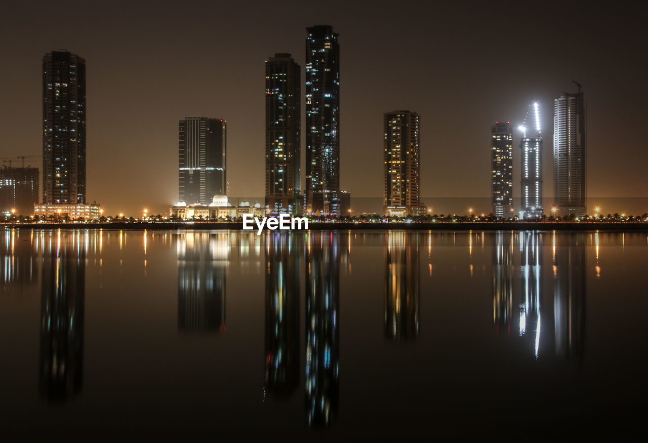 Reflection of illuminated buildings in city at night