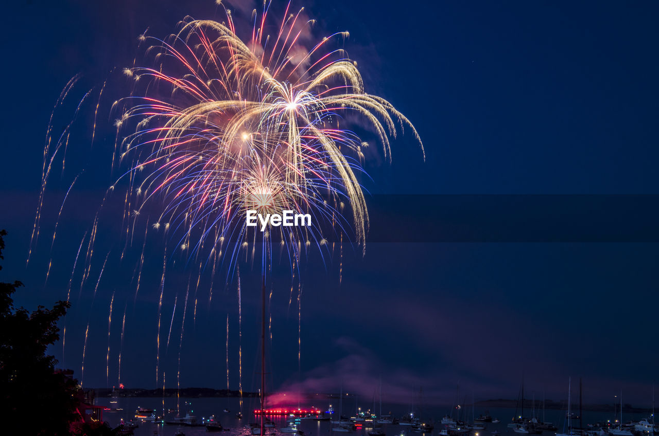 Low angle view of firework display at night