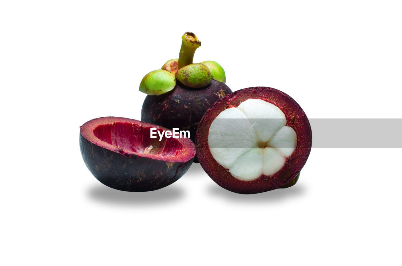 Close-up of mangosteens on white background
