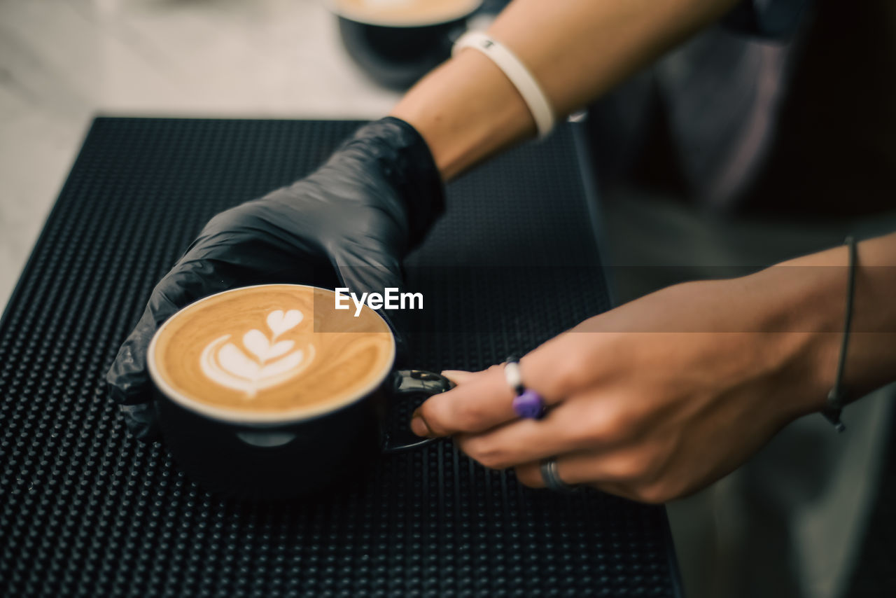 Midsection of man holding coffee