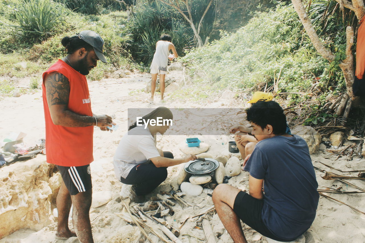 group of people, men, adult, nature, land, day, friendship, casual clothing, full length, women, plant, tree, togetherness, young adult, leisure activity, lifestyles, sitting, outdoors, clothing, high angle view