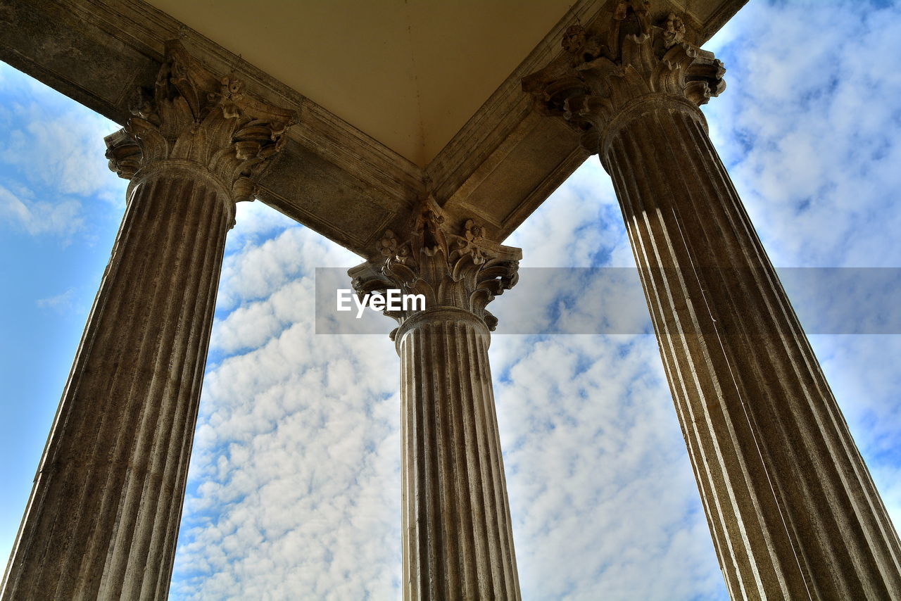 Low angle view of colonnade against sky