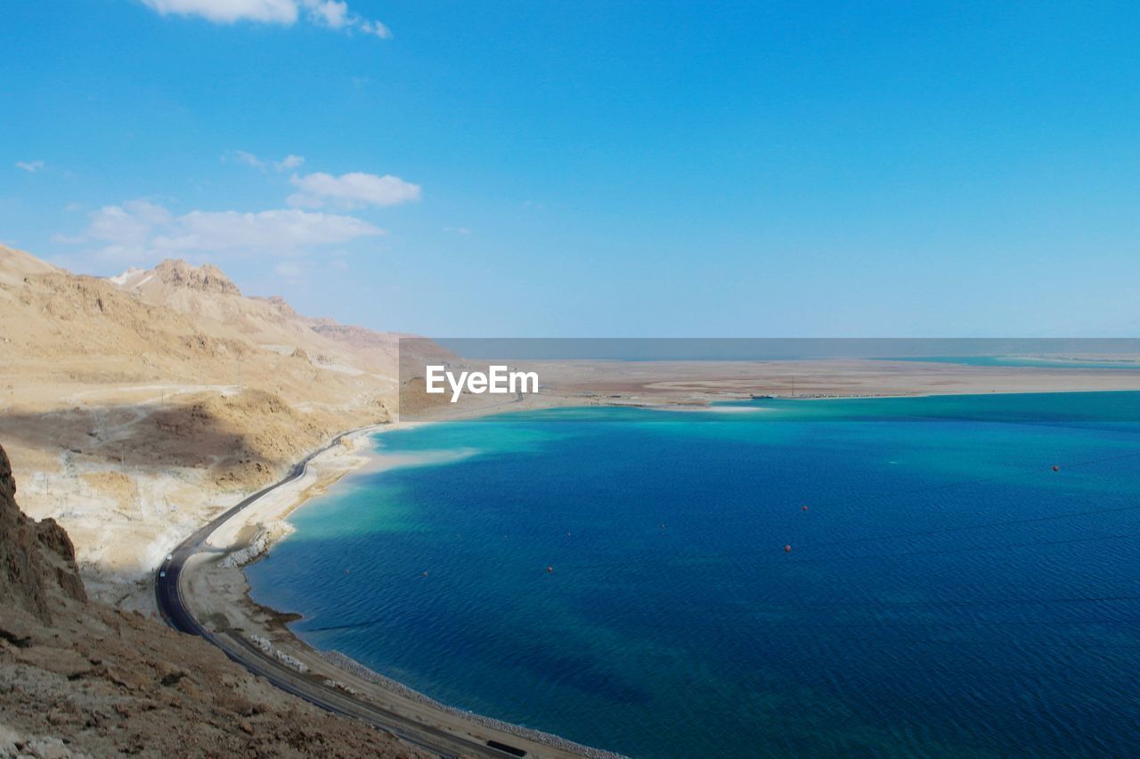 View of calm blue sea against blue sky