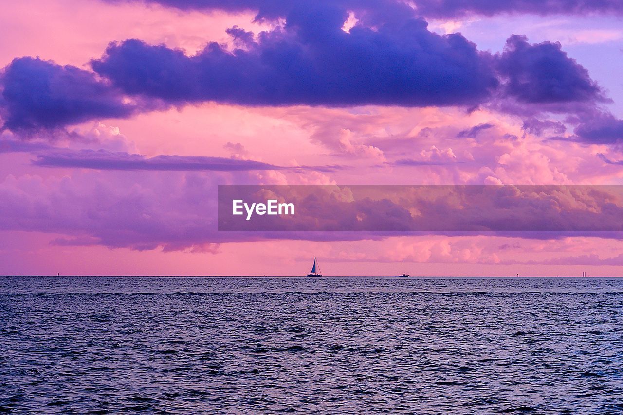 SILHOUETTE OF SAILBOAT IN SEA