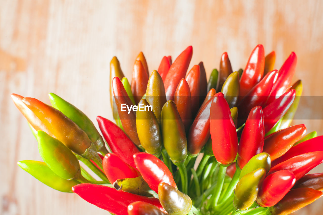 flower, plant, food and drink, food, freshness, red, produce, petal, healthy eating, vegetable, no people, nature, close-up, multi colored, wellbeing, macro photography, green, vibrant color, spice, indoors, flowering plant, wood, beauty in nature, floristry, large group of objects, pepper