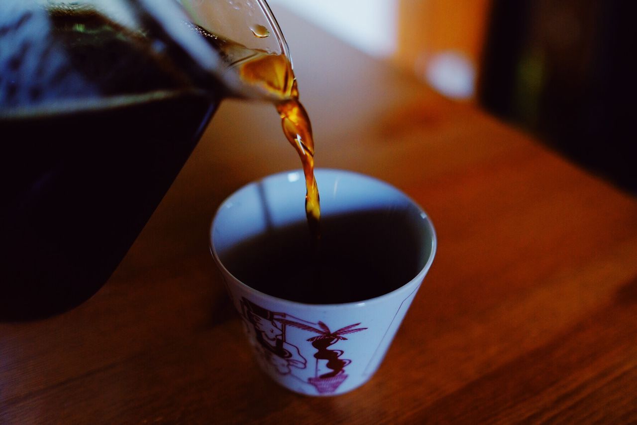 CLOSE-UP OF COFFEE CUP IN GLASS