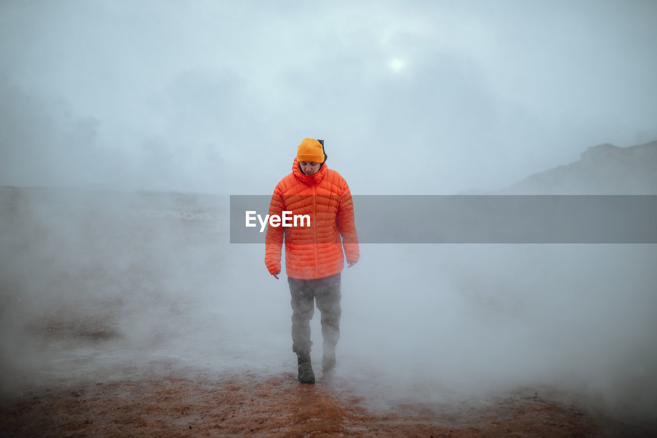 Man walking in winter in a fog day