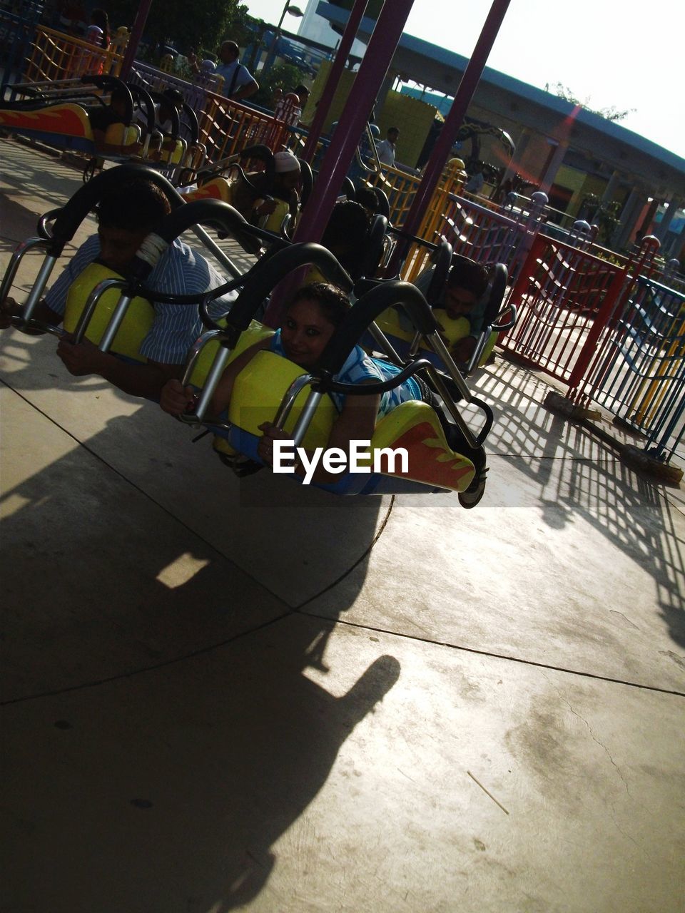 LOW ANGLE VIEW OF GIRL SITTING ON SWING