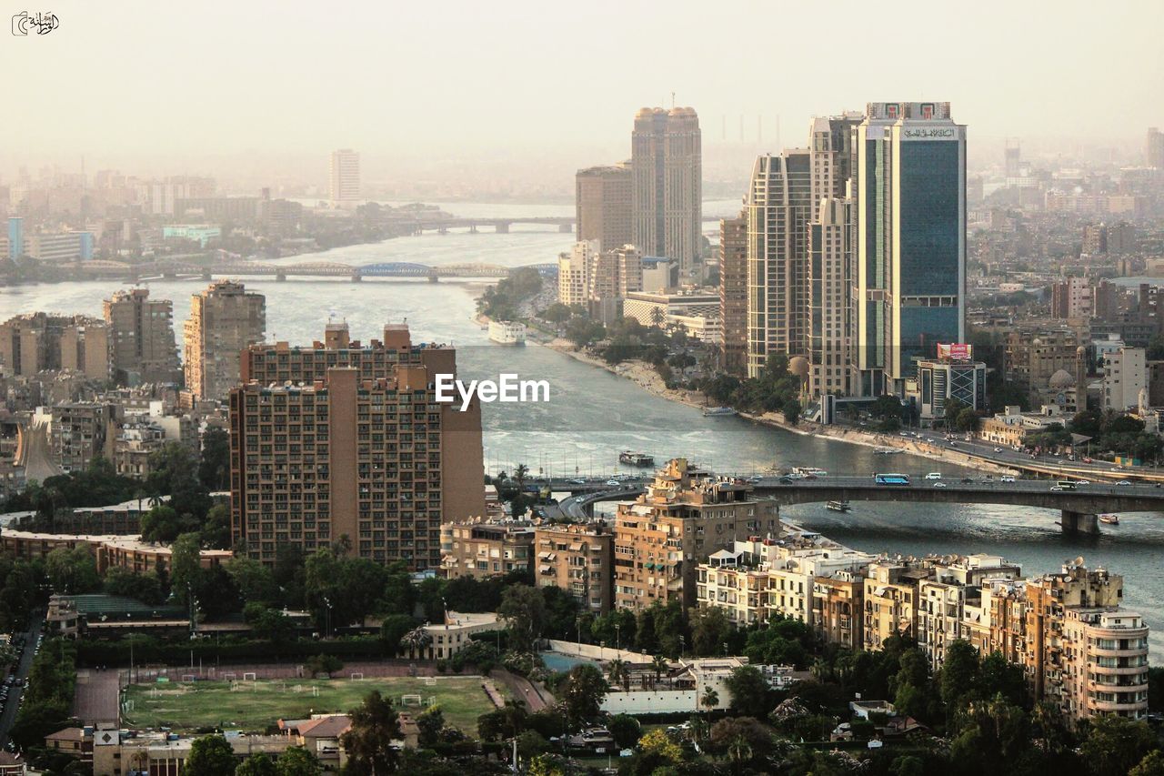 High angle view of buildings by sea against sky