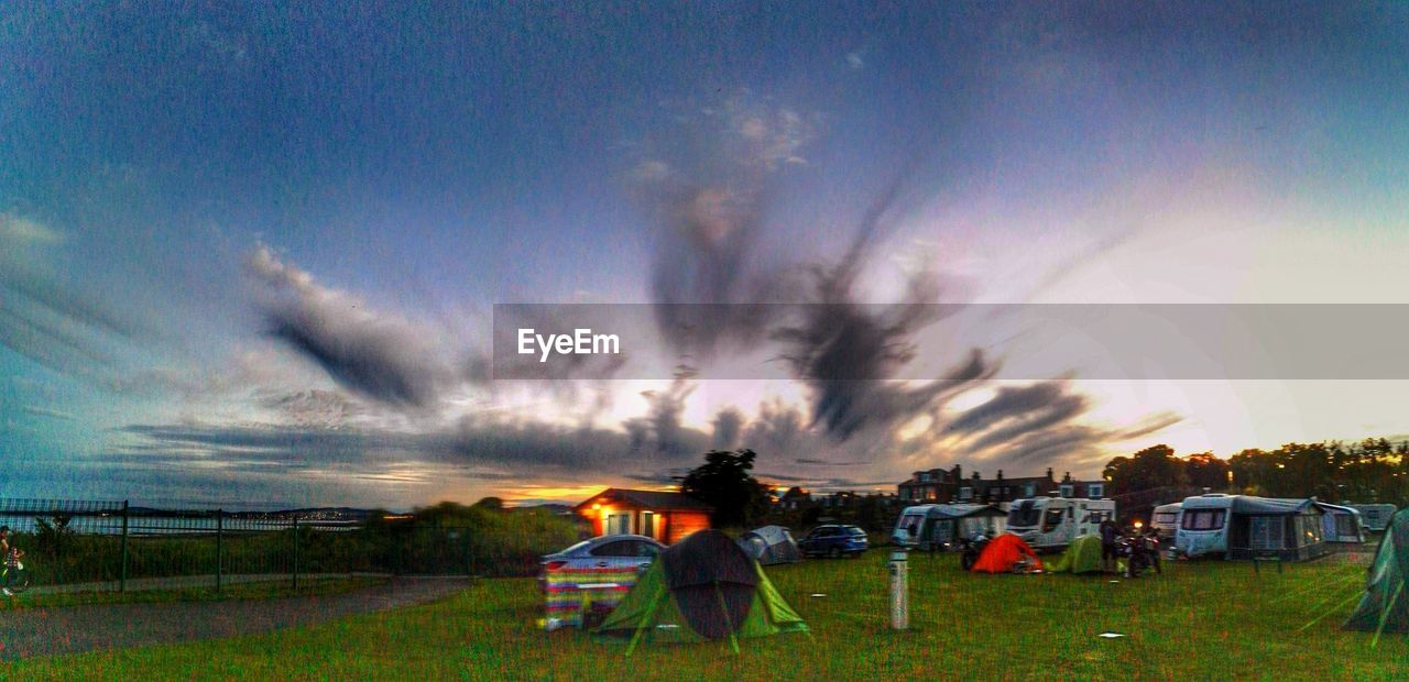 VIEW OF GRASSY FIELD AT SUNSET