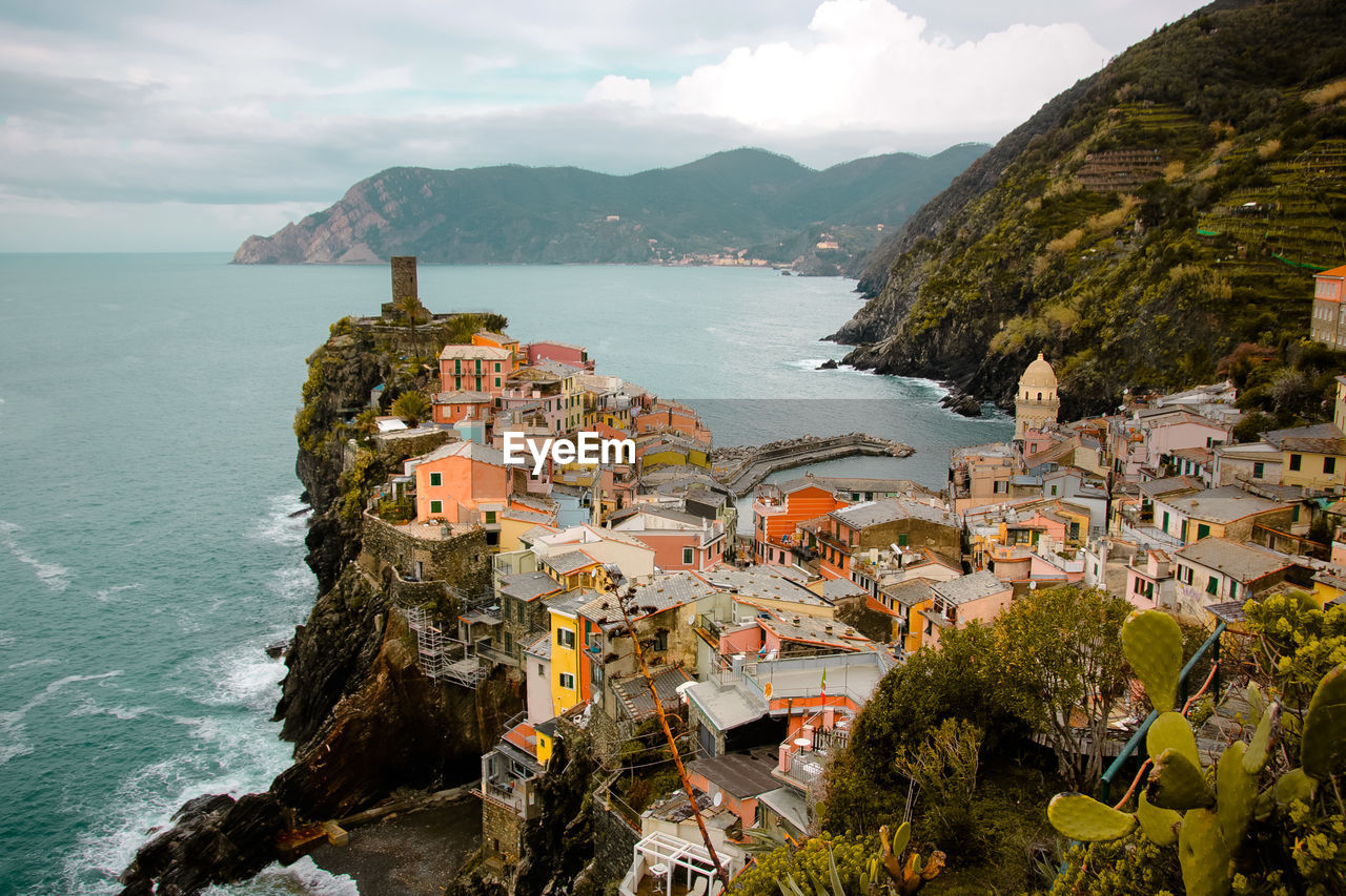 High angle view of buildings by sea against sky