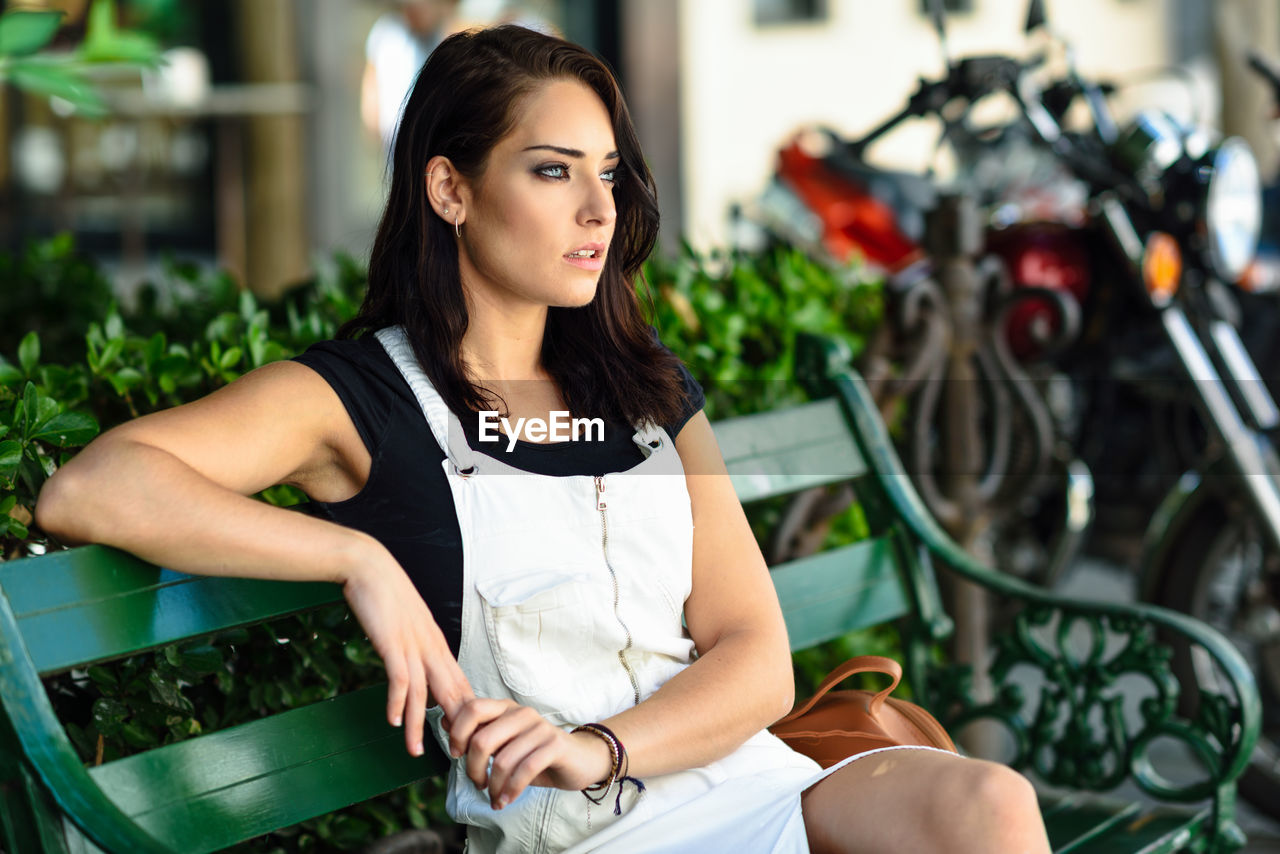 Thoughtful woman sitting on bench