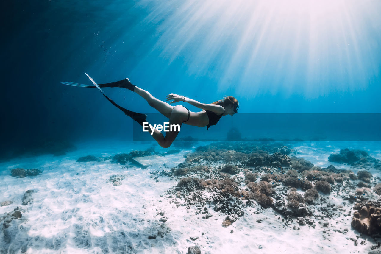 low angle view of man swimming in sea