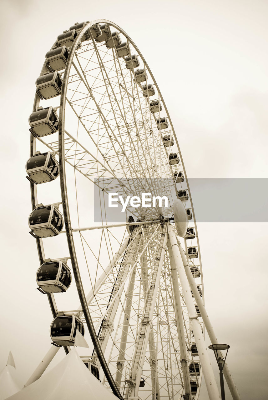 Low angle view of ferris wheel against sky