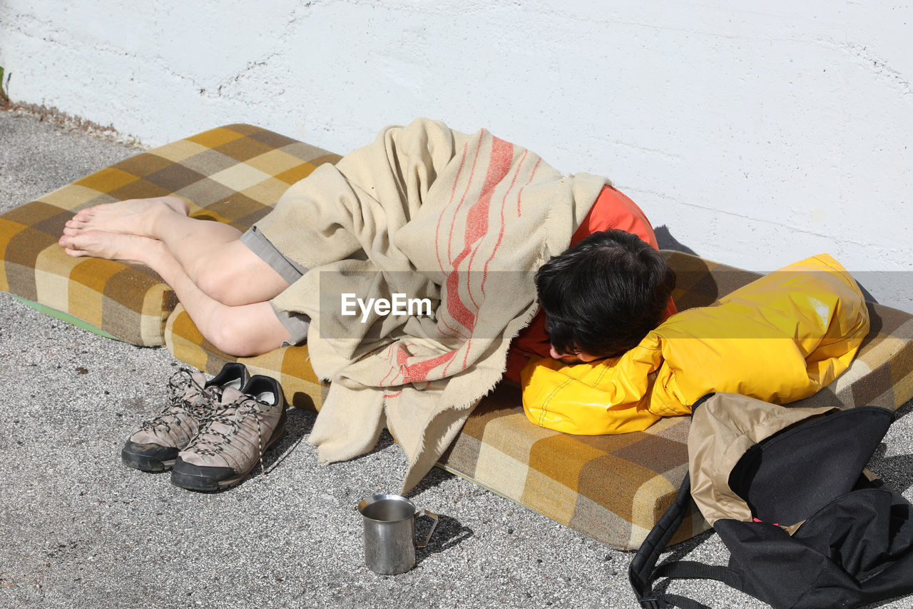 High angle view of boy sleeping on floor