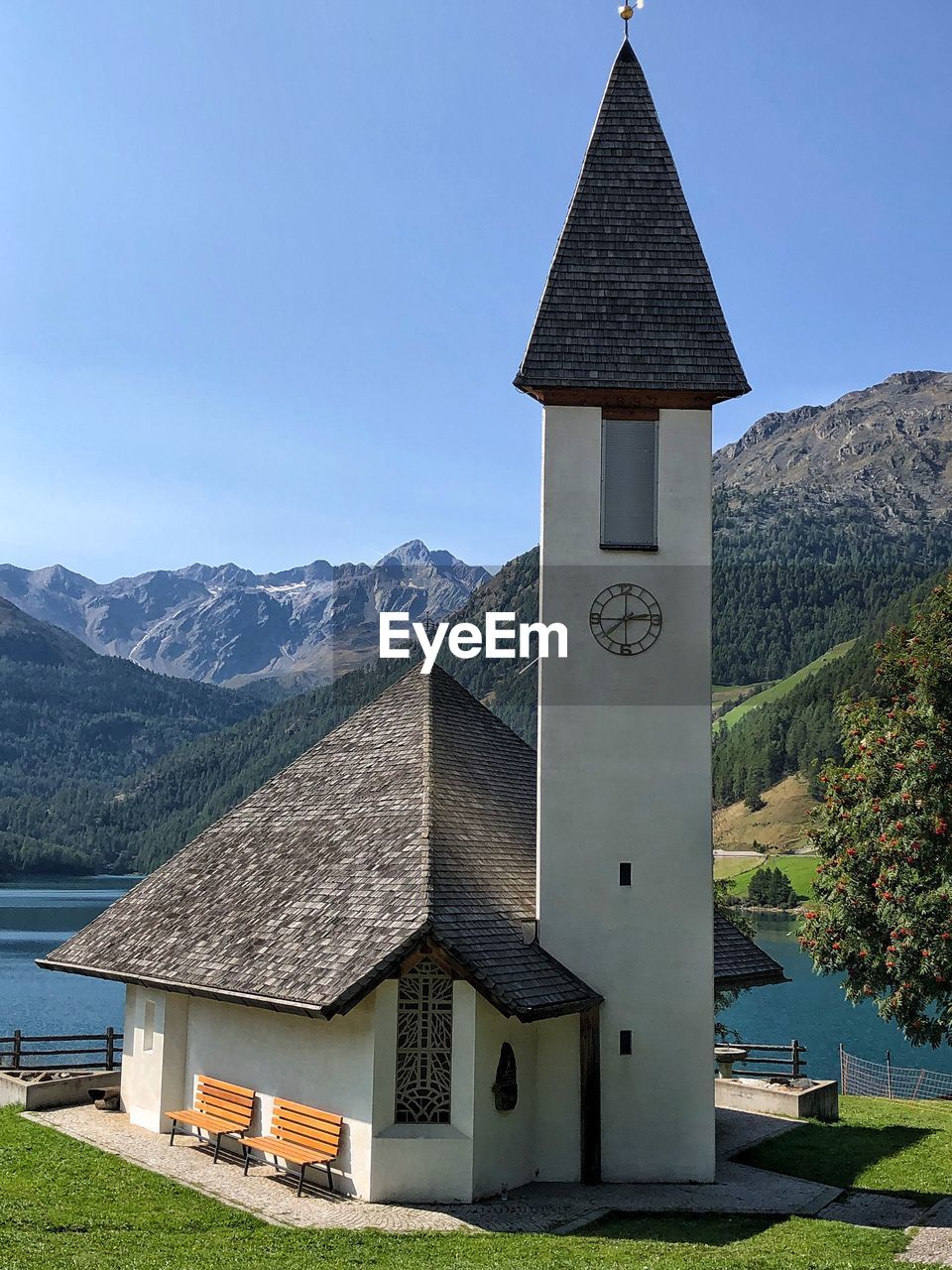 Exterior of house by building against clear sky