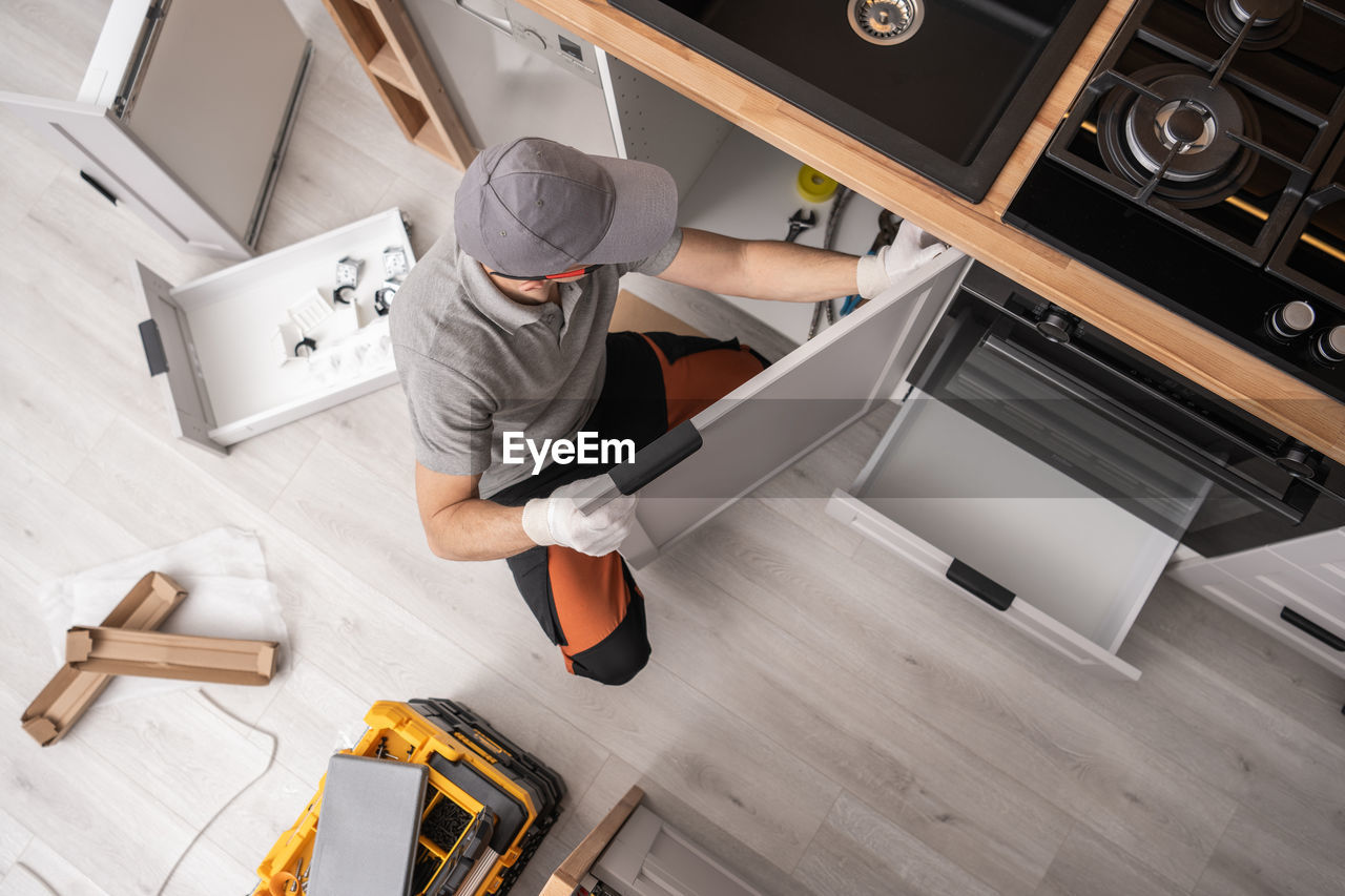 high angle view of man working on floor