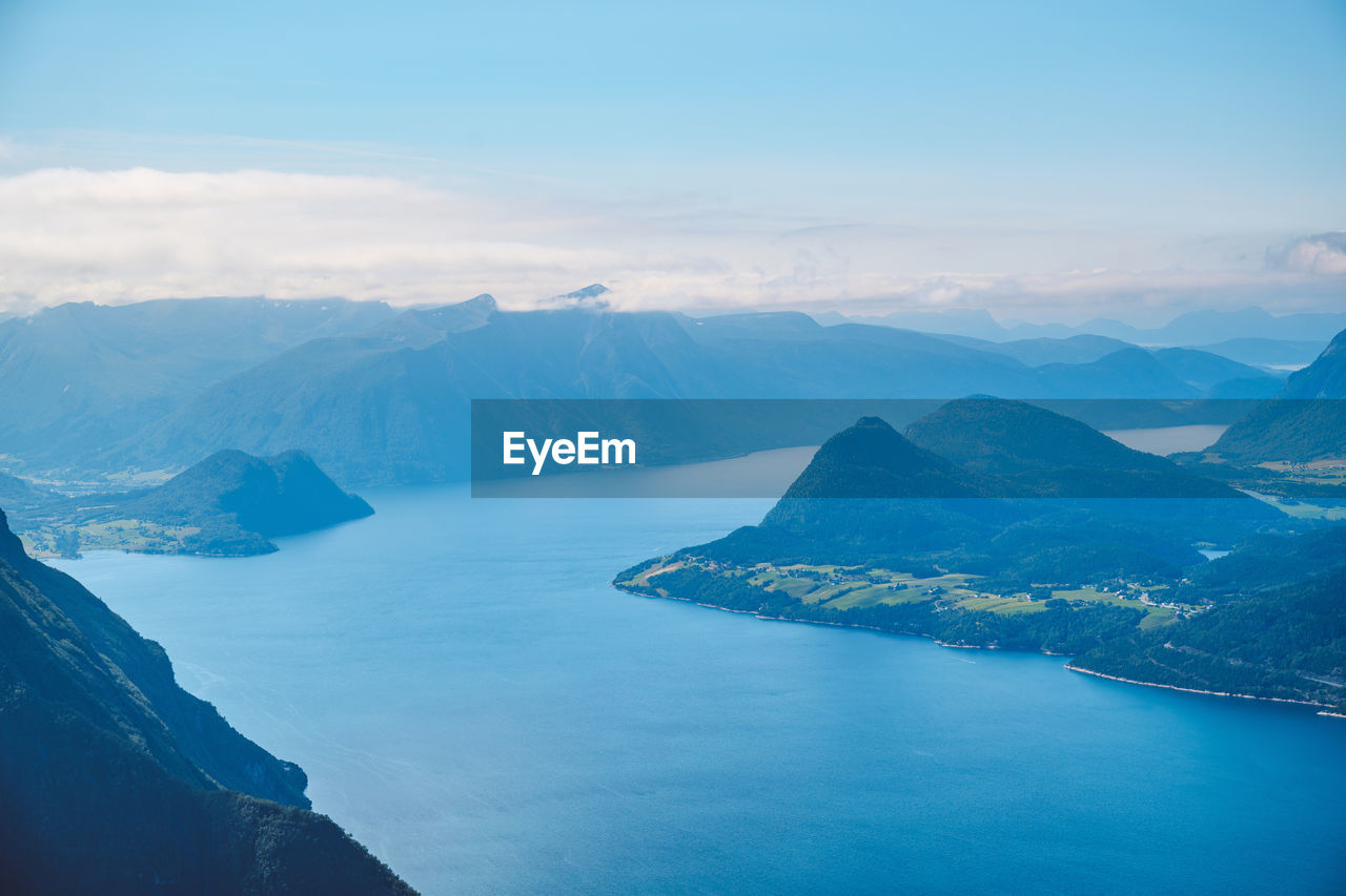 Aerial view of sea and mountains against sky