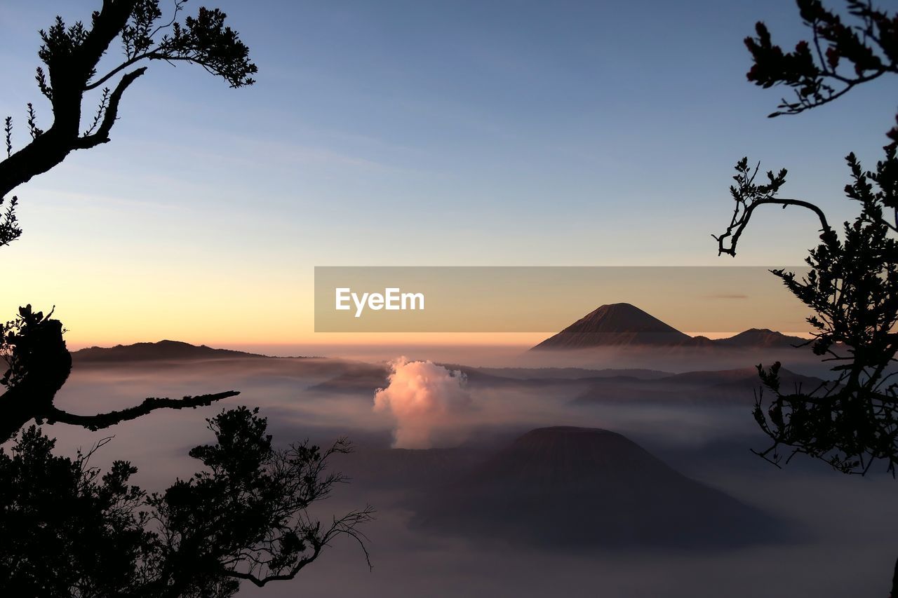 Scenic view of silhouette mountains against sky at sunset