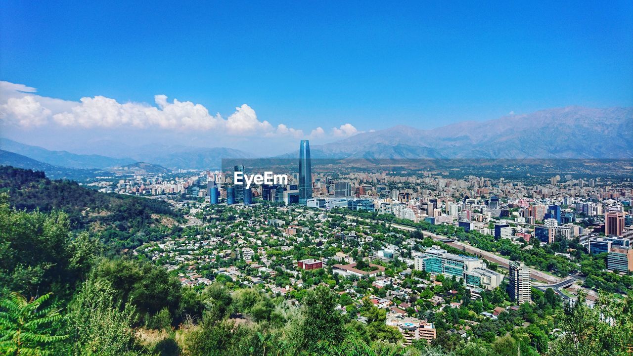 View of cityscape against cloudy sky