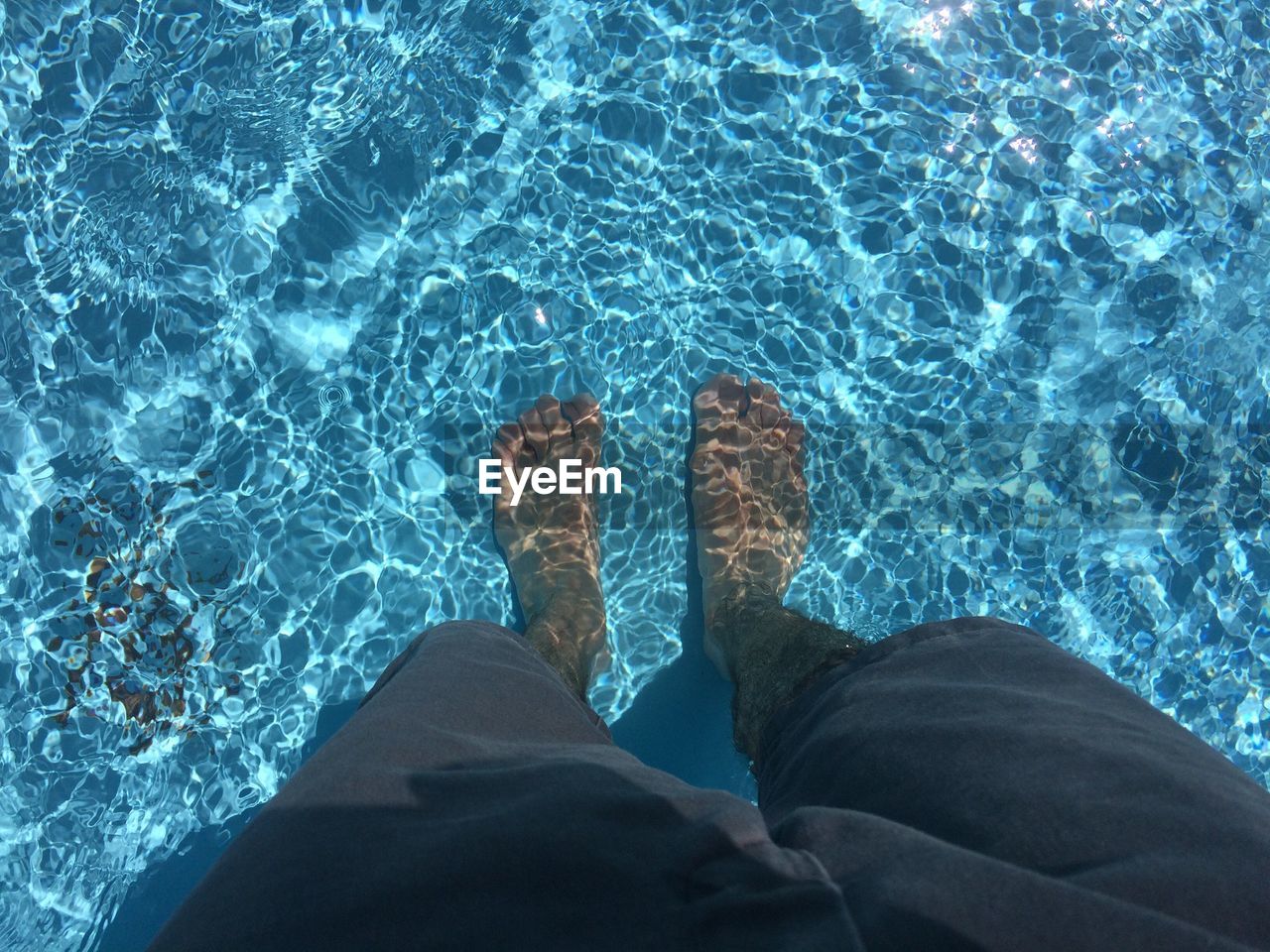 Low section of man in swimming pool