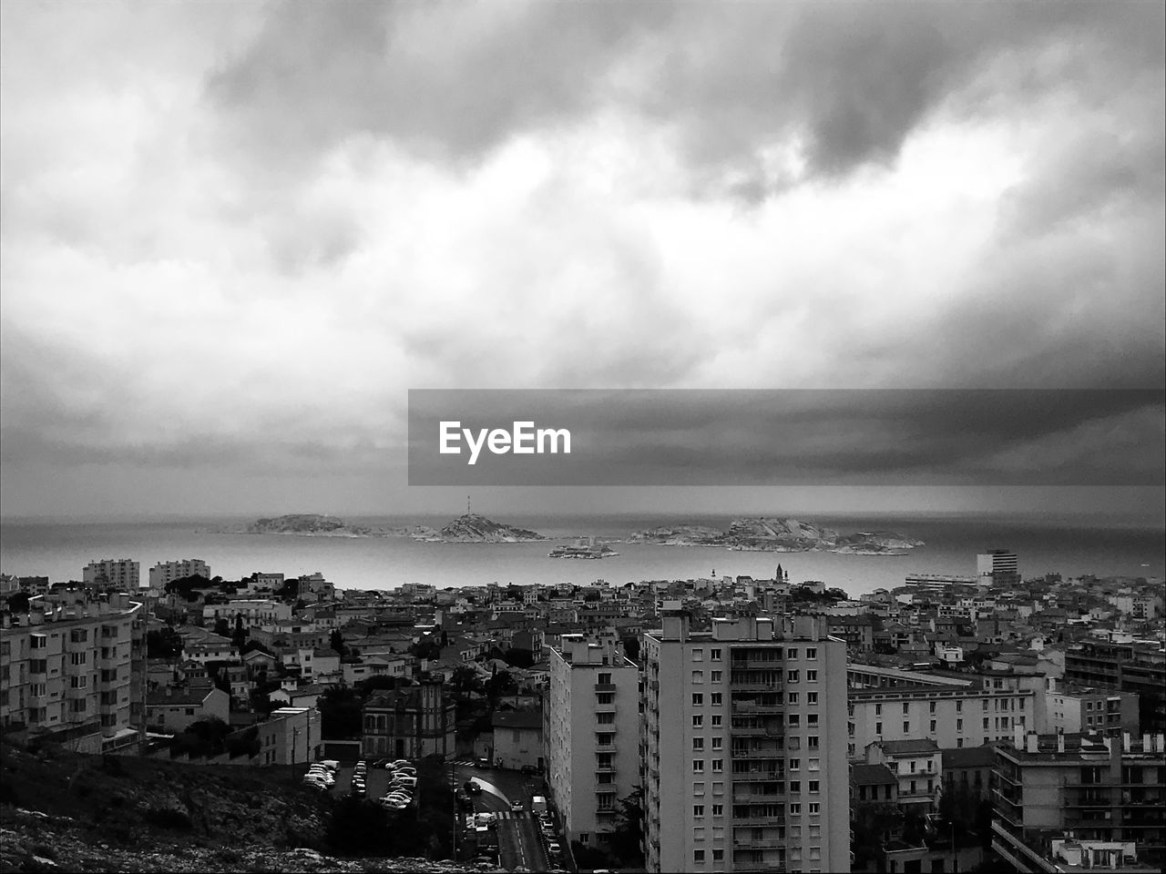 High angle view of townscape by sea against sky