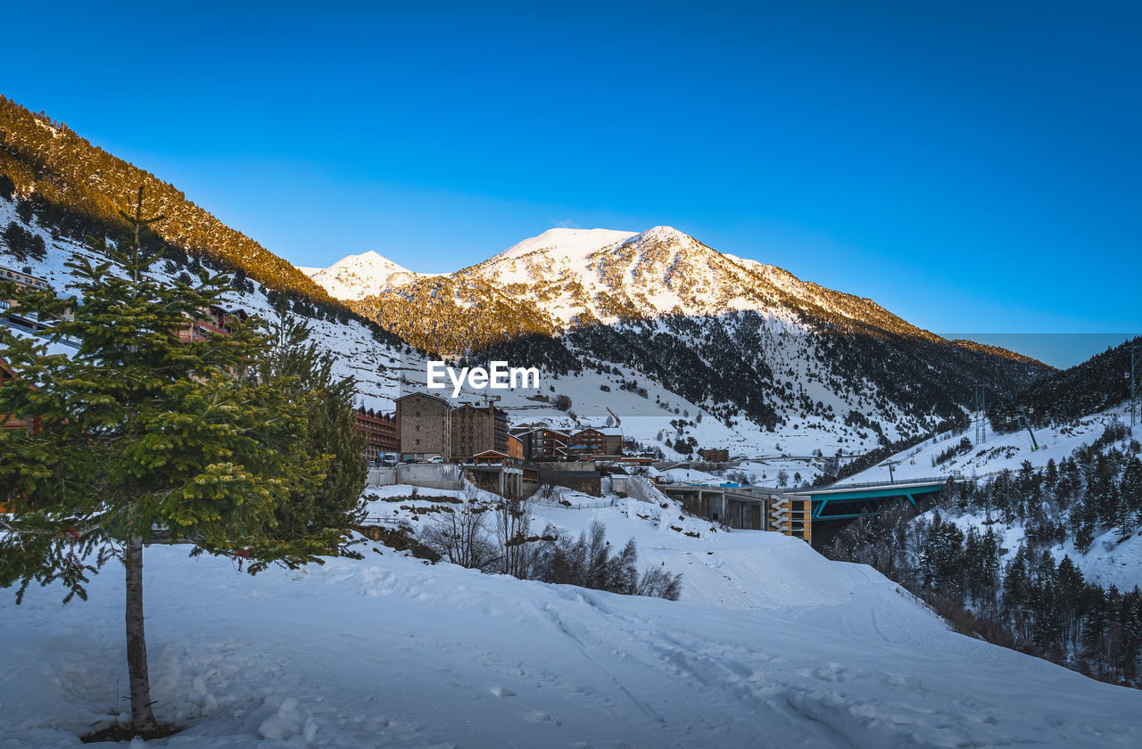 Soldeu village with mountain range illuminated by sunset in the background, andorra