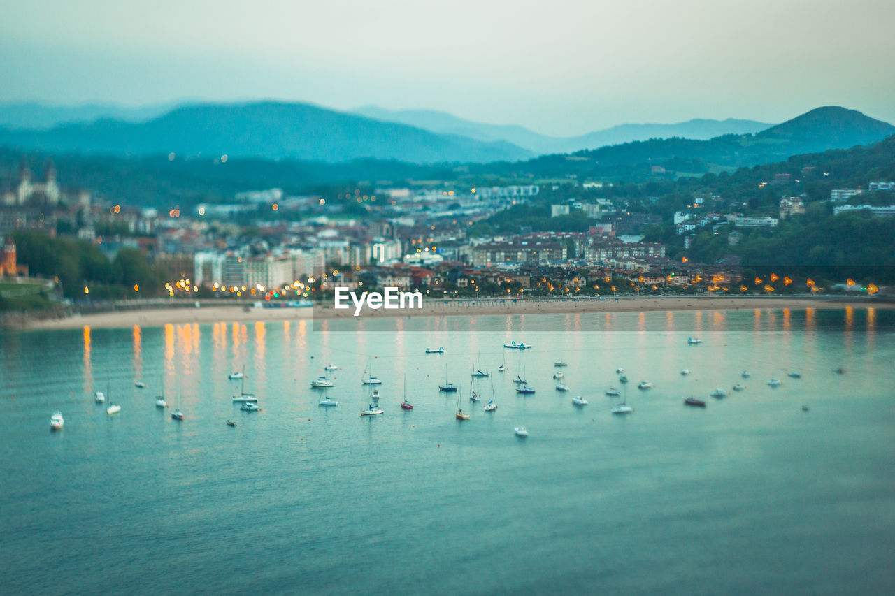 Scenic view of sea by city against sky