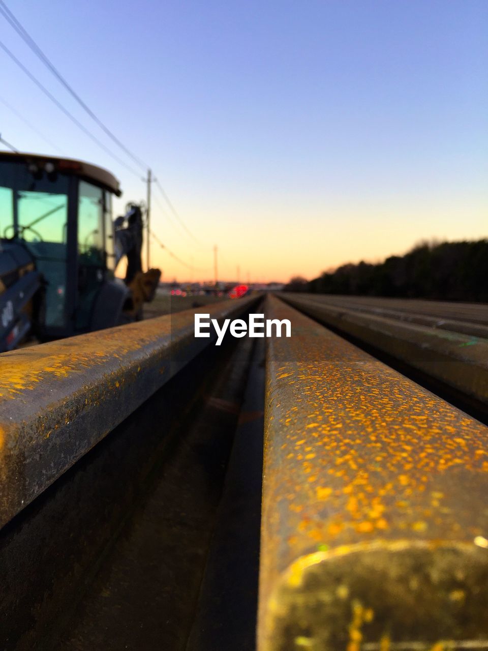 Railroad track against sky during sunset