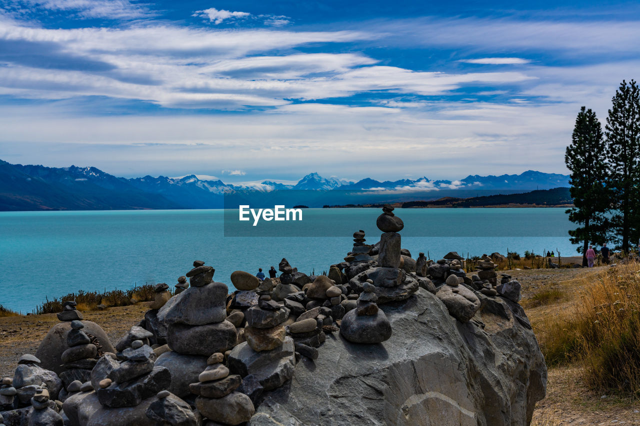 STACK OF ROCKS ON SHORE AGAINST SKY