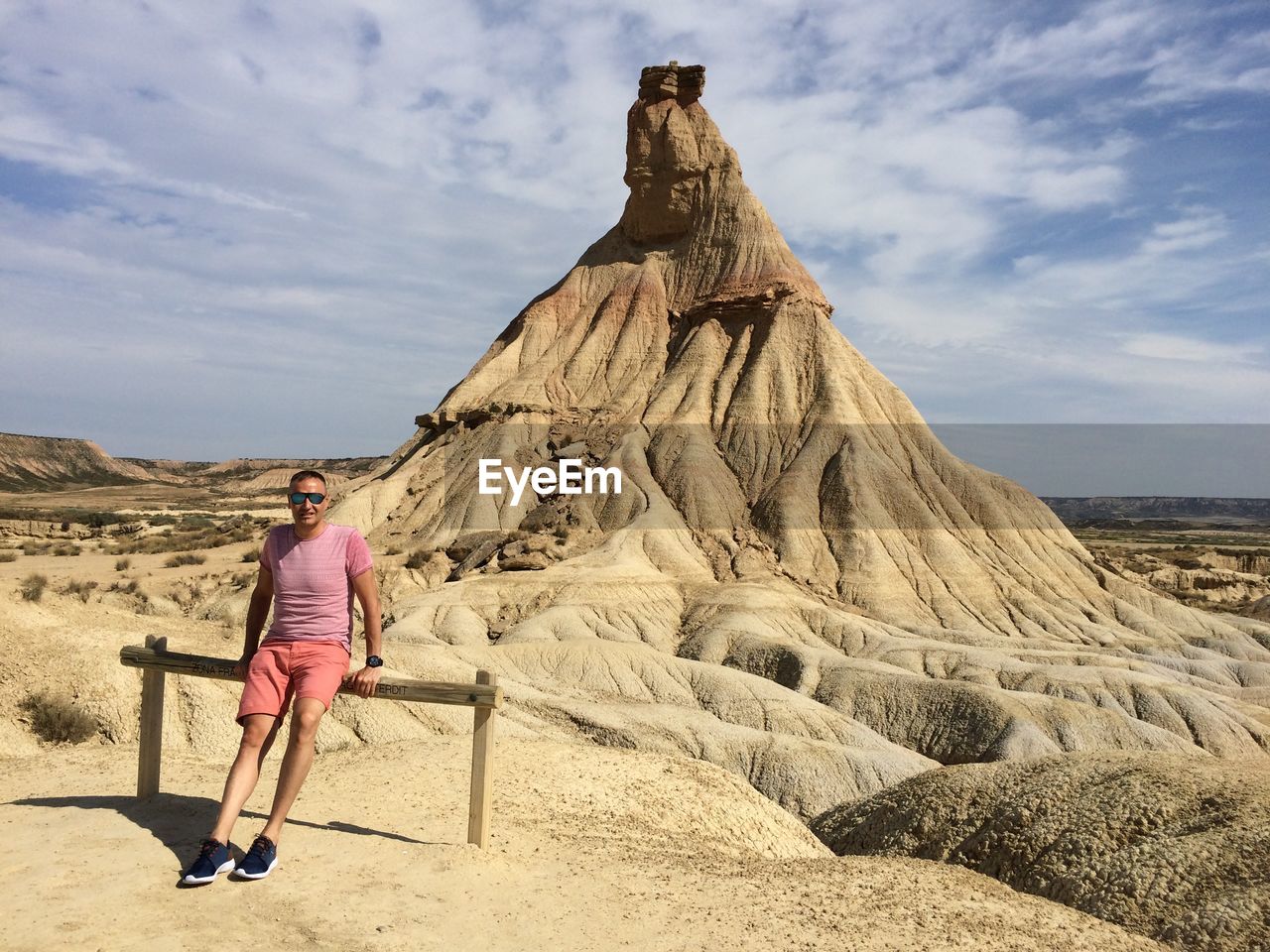 Rear view of man on rock against sky