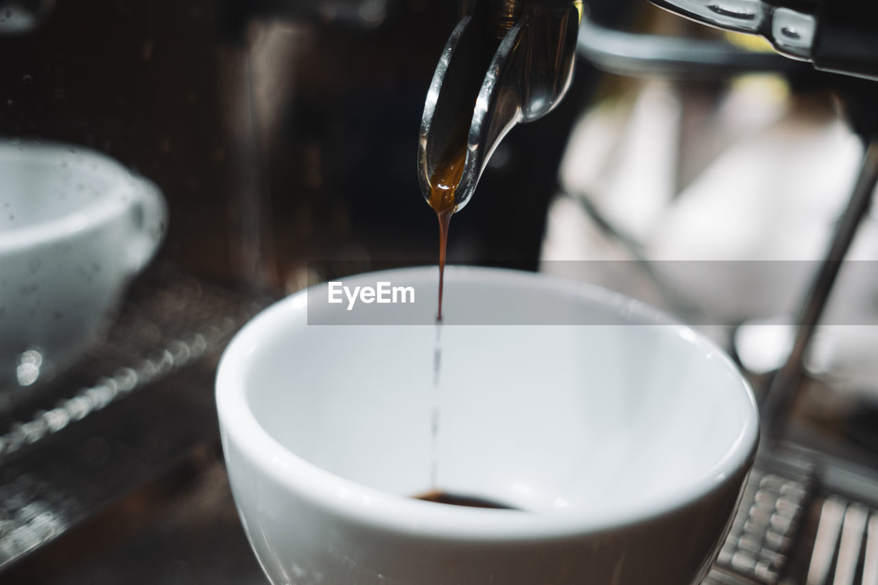 CLOSE-UP OF COFFEE CUP IN WATER