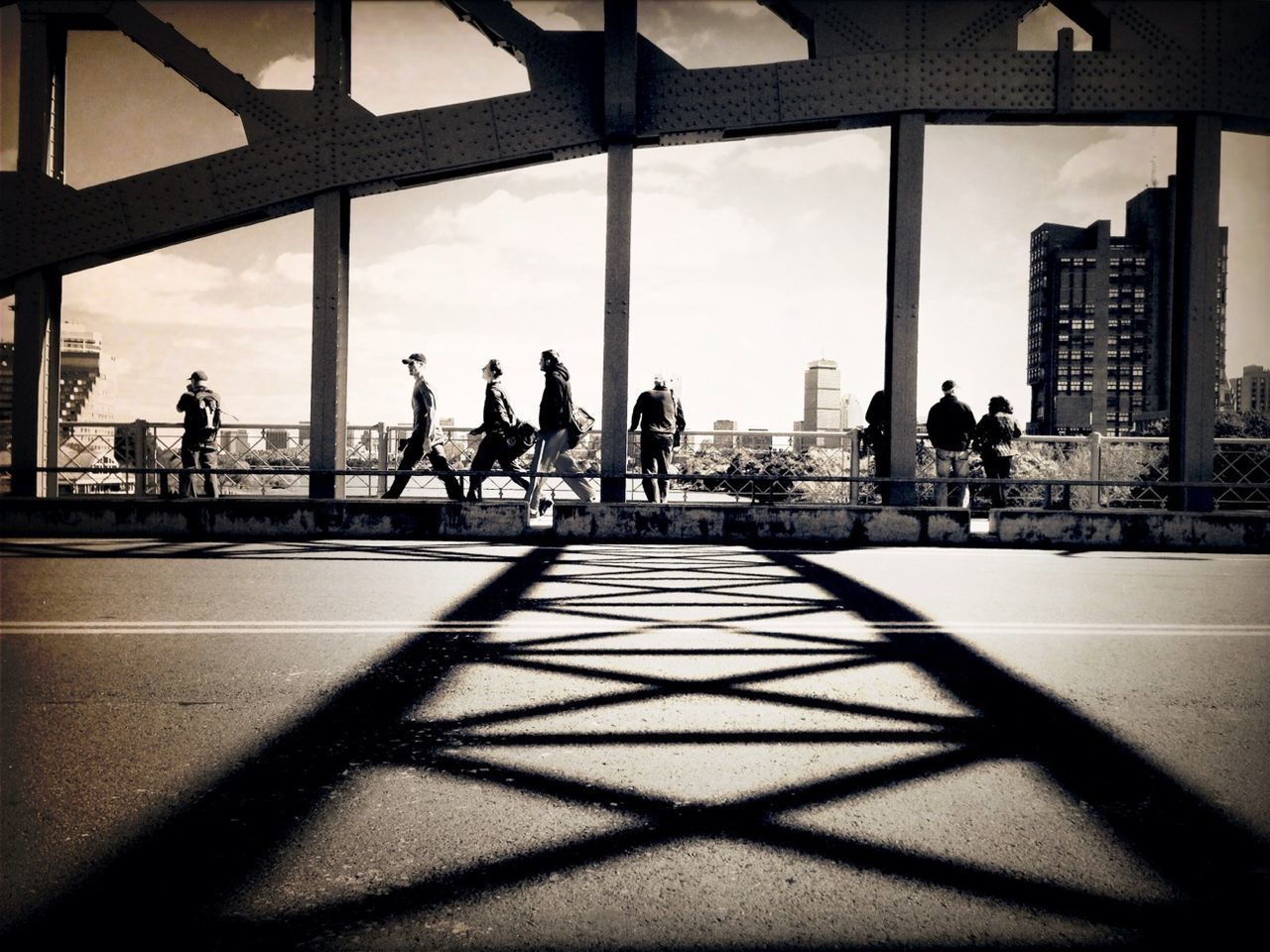 group of people, architecture, black, built structure, city, sunlight, light, shadow, silhouette, men, nature, darkness, sky, adult, monochrome, crowd, white, urban area, building exterior, city life, women, reflection, black and white, transportation, day, lifestyles, large group of people, outdoors, travel, travel destinations, leisure activity, group, monochrome photography, window, building