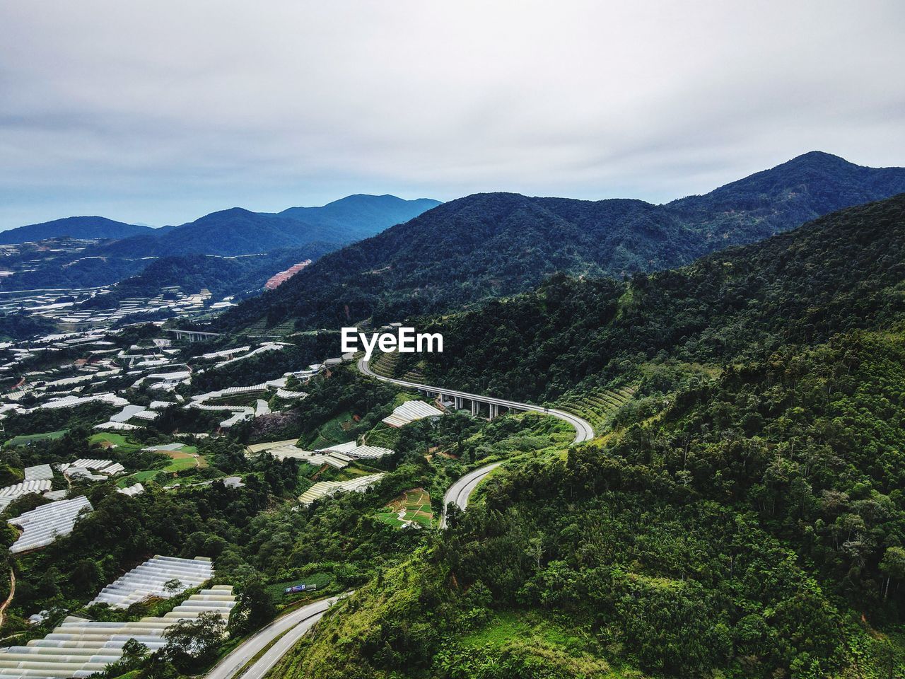 High angle view of green landscape against sky