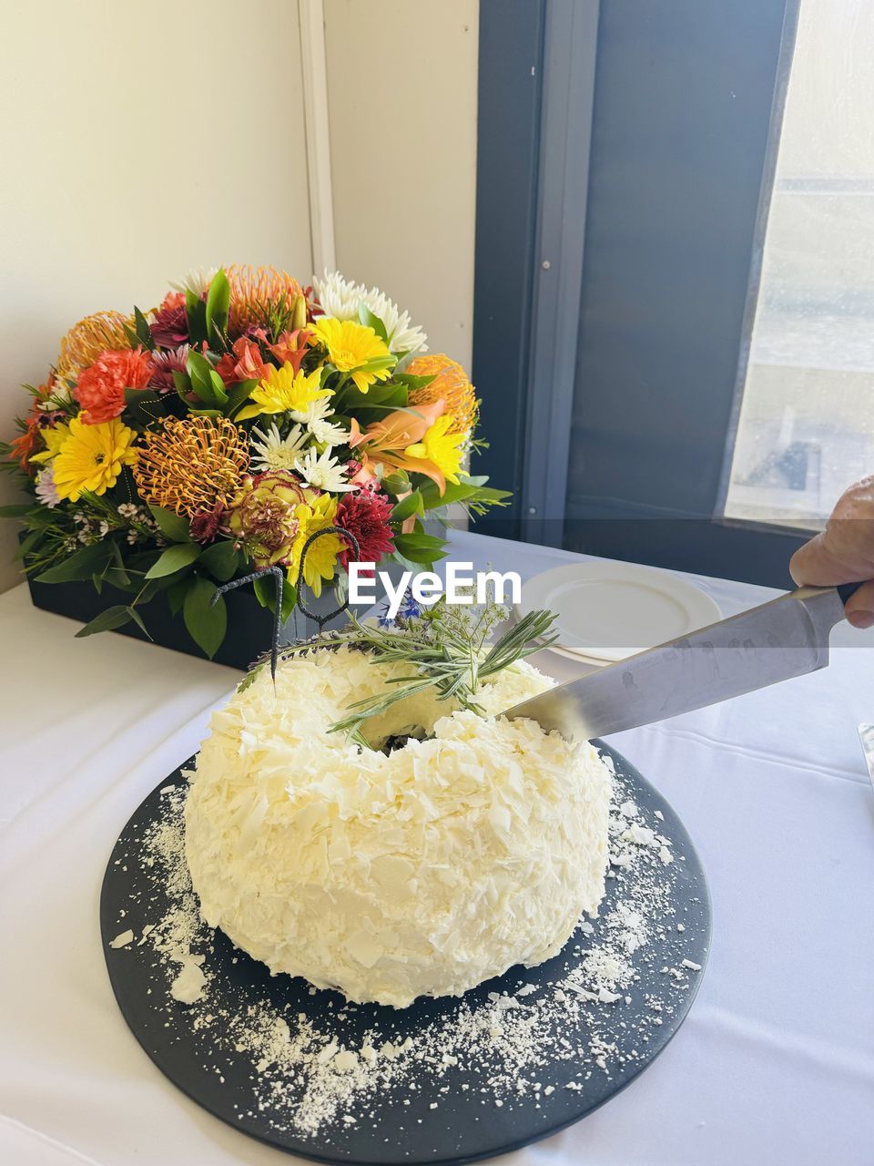 flower, flowering plant, freshness, plant, cake, yellow, birthday cake, indoors, food and drink, floristry, food, flower arrangement, nature, table, floral design, meal, dessert, plate, bouquet, arrangement, decoration, vase, flower head, home interior, lifestyles, sweet food, high angle view