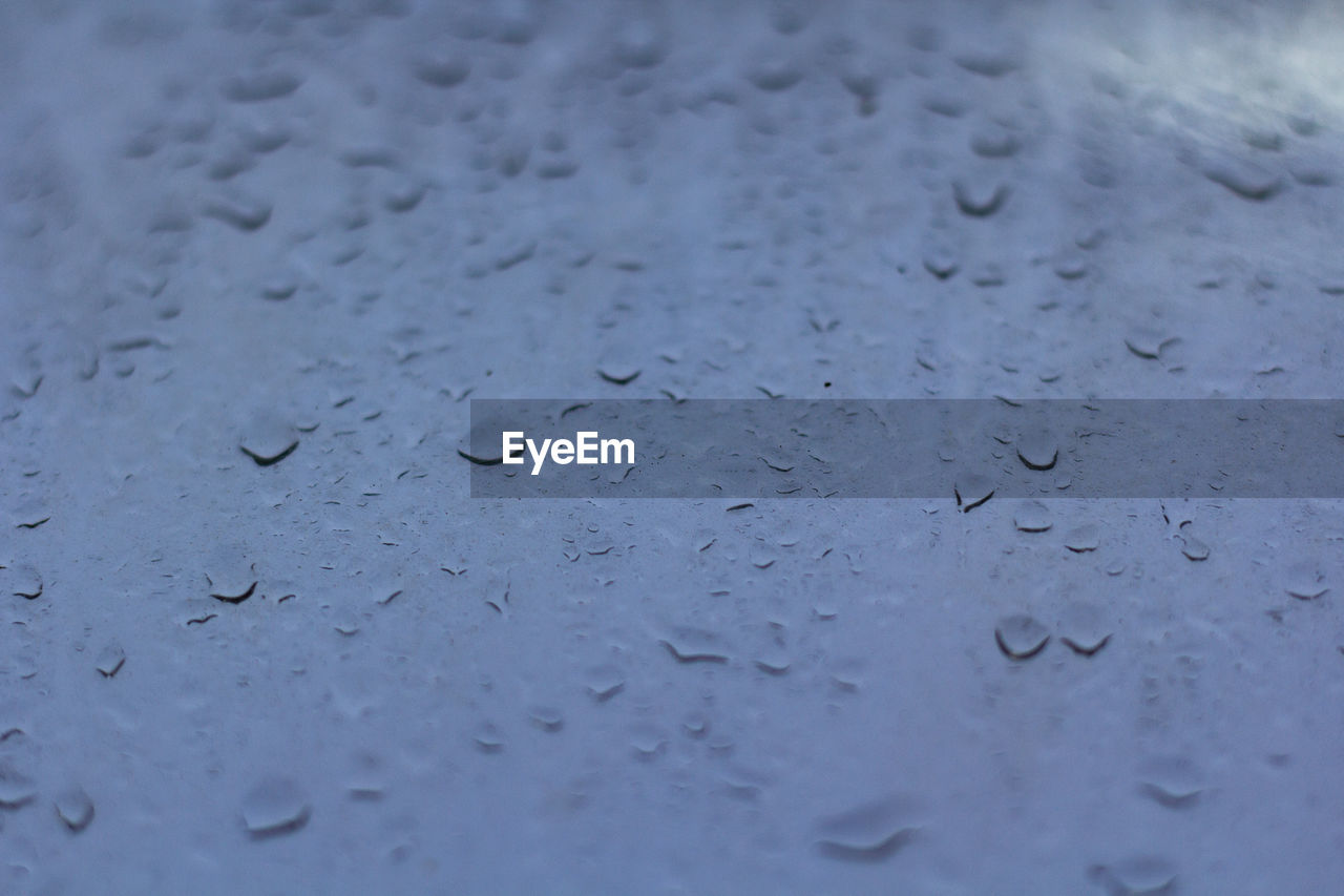 FULL FRAME SHOT OF RAINDROPS ON WINDOW