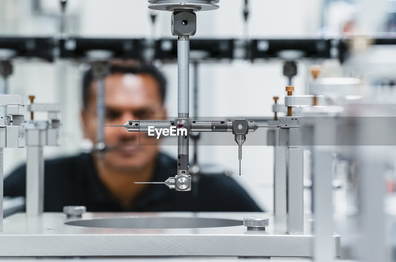 Engineer examining automated machine in industry