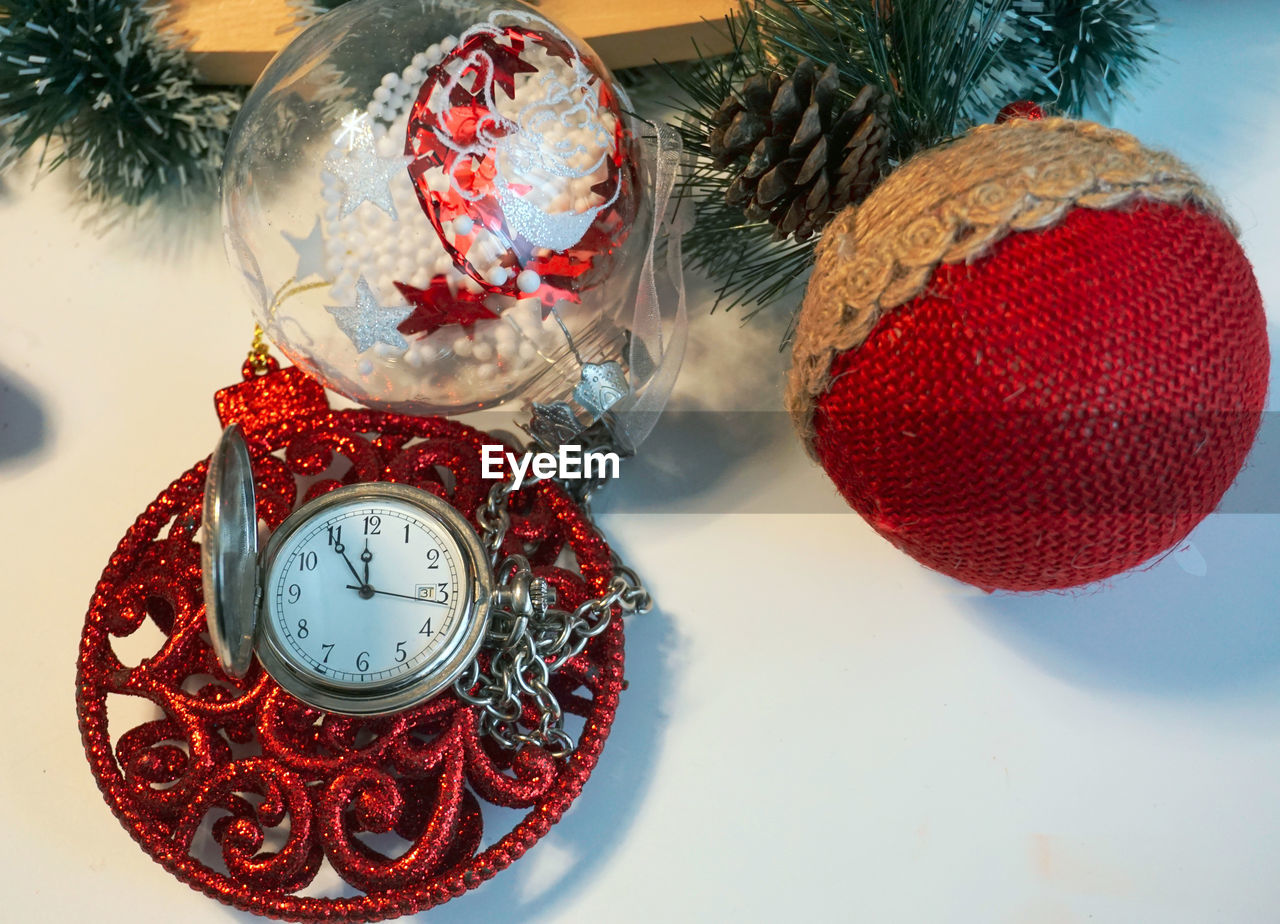 High angle view of christmas decoration and pocket watch on table