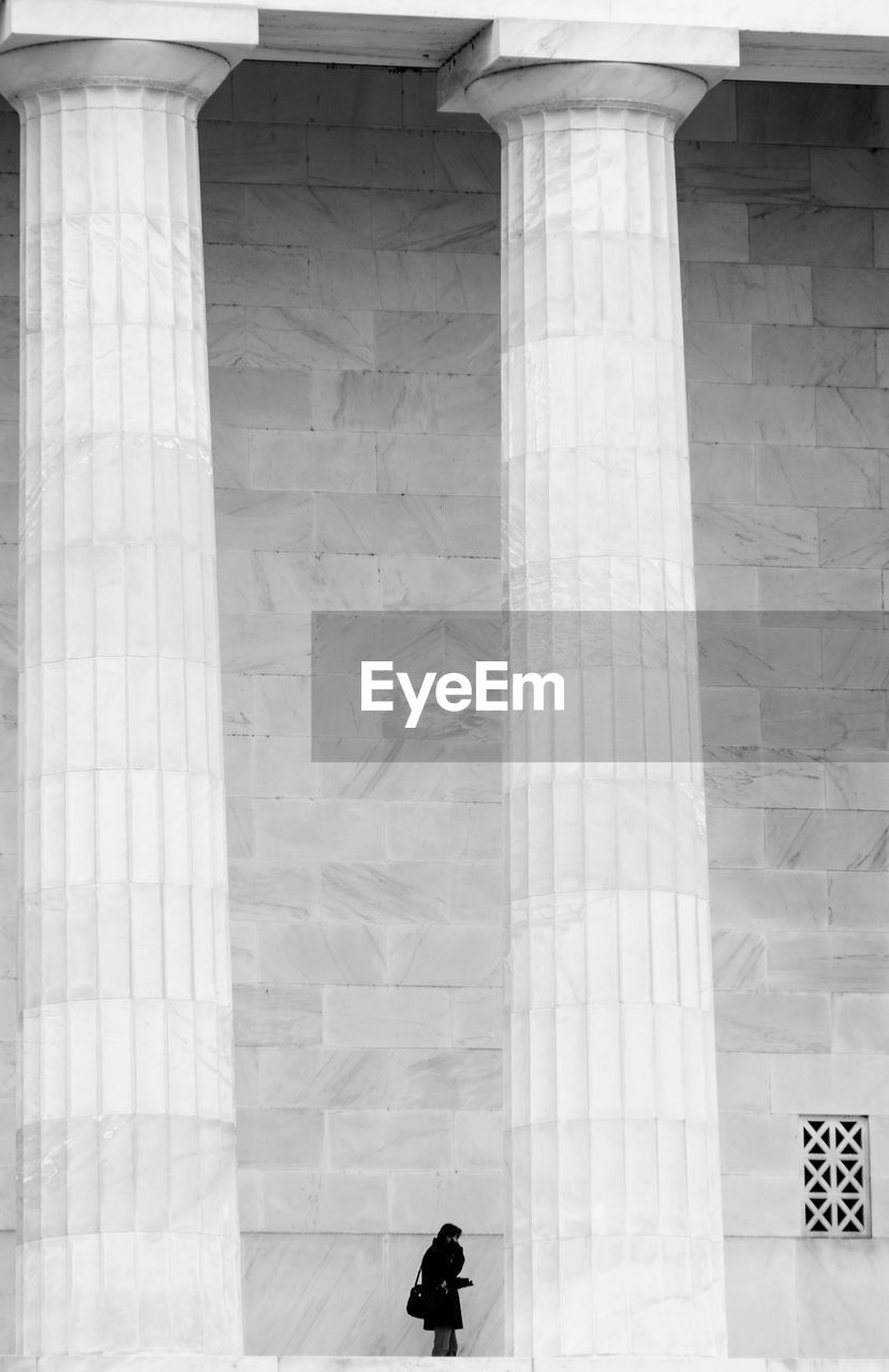 Man standing by large columns at lincoln memorial