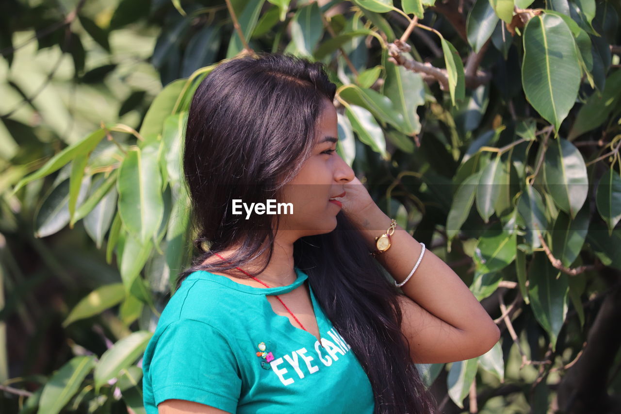 Side view of woman looking away outdoors