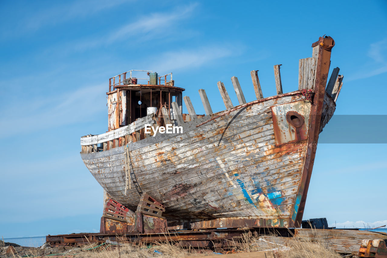 Old rusty ship against blue sky